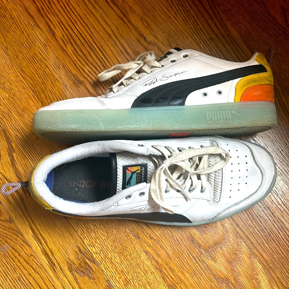 Multi colored white leather low top Puma sneakers. Size 11
